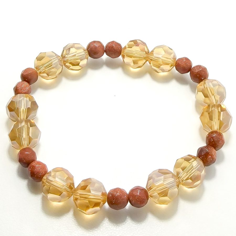 A bracelet of faceted amber crystals and copper goldstone beads